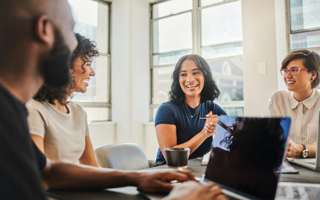 Photo of people working together and smiling